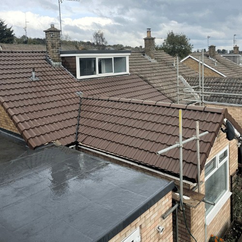 New flat roof finished beside tiled roofs