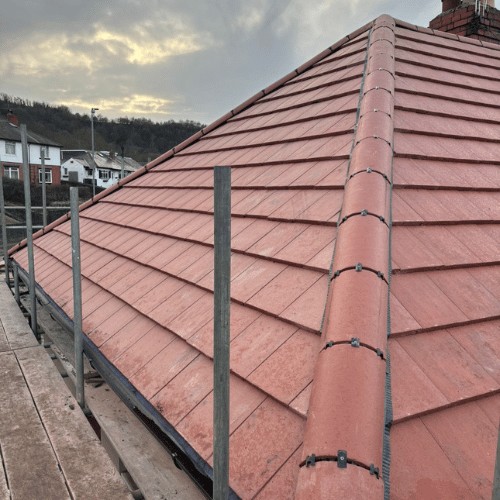 Red tiled roof with matching ridge, scaffold in place